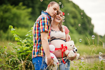 Happy young couple expecting baby, pregnant woman with husband