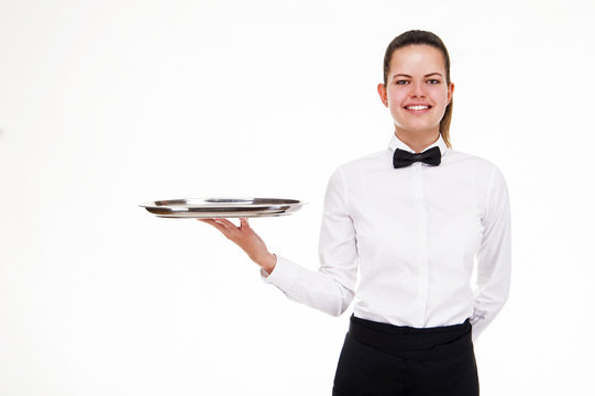 Young woman in waiter uniform holding tray isolated over white b
