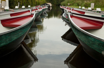 Colorful rental boats parked on a canal in beautiful village of Giethoorn in Netherlands.