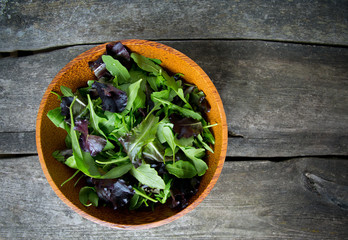 fresh green salad mix in a wooden bowl
