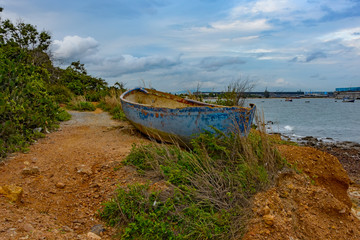 Naklejka na ściany i meble Old derelict boat on pebble beach.