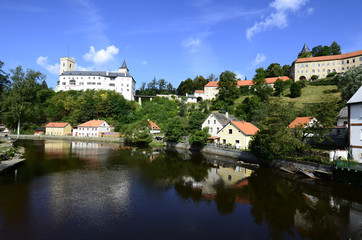 Rozmberk nad Vltavou, Czechia, castle Rozmberk and homes reflecting in river Mltava (Moldau)