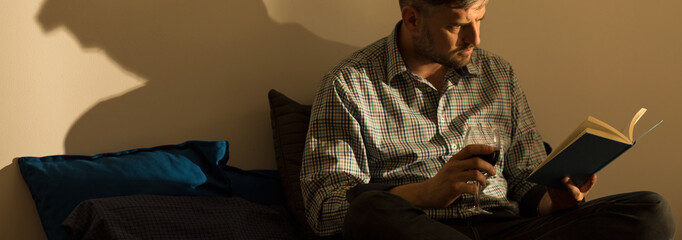 Focused man reading book