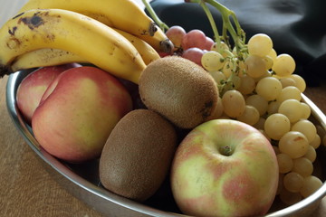 tray full of assorted fruits on a wooden table