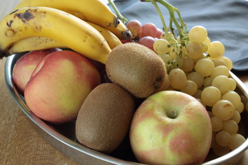 tray full of assorted fruits on a wooden table
