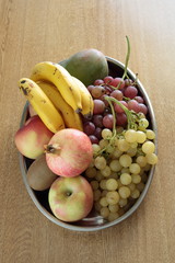tray full of assorted fruits on a wooden table