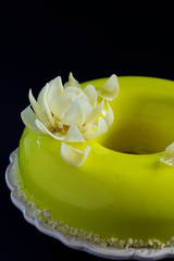 Pineapple mousse cake covered with a mirror coating.