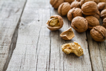 Whole walnuts on rustic background