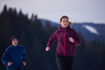Fototapeta premium couple jogging outside on snow