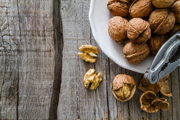 Whole walnuts on rustic background