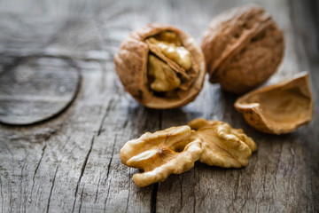 Whole walnuts on rustic background