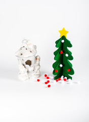 Small green Christmas tree with a golden star decoration isolate