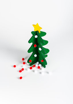 Small green Christmas tree with a golden star decoration isolate
