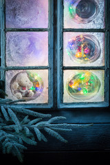Adorable teddy bear in frozen window for Christmas
