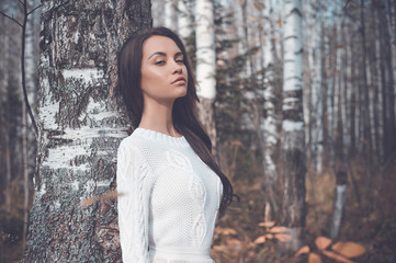 Beautiful lady in a birch forest