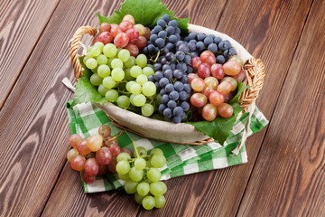Bunch of red, purple and white grapes in basket