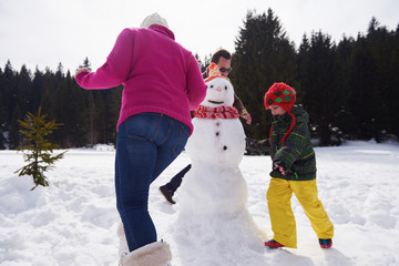 happy family building snowman