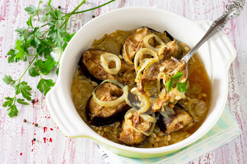 Grilled mackerel fish baked with onions and pine nuts