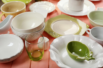 Different tableware on wooden table close up