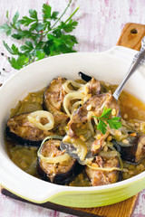 Grilled mackerel fish baked with onions and pine nuts