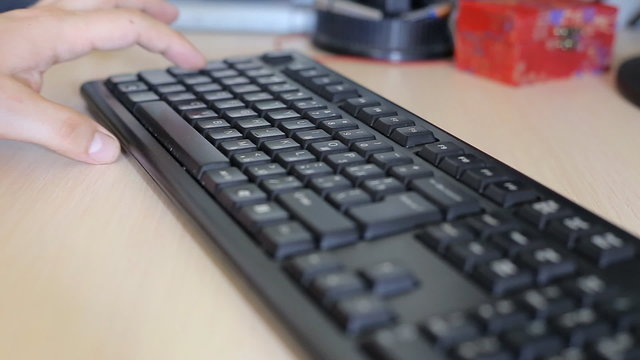 Man typing on computer keyboard 
