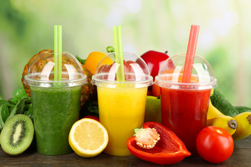 Fototapeta premium Fresh juice mix fruit, healthy drinks on wooden table, on bright background