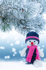 Christmas background with a snowman and a Christmas tree branch
