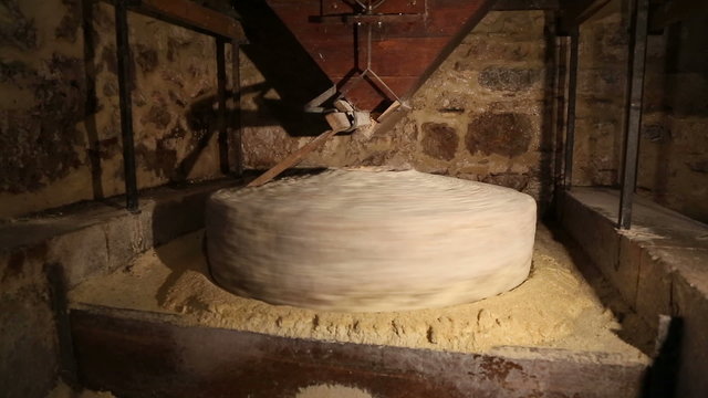 Millstone in a water mill grinds corn 4 of 7