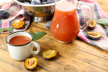 Plum Juice in jar and mug with fresh fruits