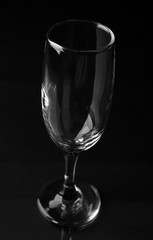 Empty champagne glass on black background