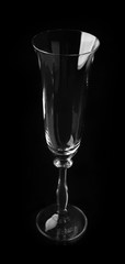 Empty champagne glass on black background
