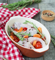 carp steak with rosemary and pepper in a ceramic form