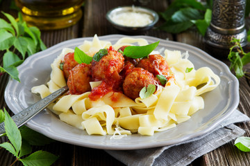 meatballs in tomato sauce with basil with pasta tagliatelle.