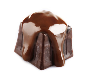 Chocolate poured on candy isolated on white