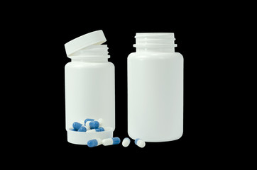 some pills of a white and blue colors with two white jar