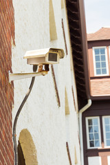 A CCTV Camera attached to a wall on a building