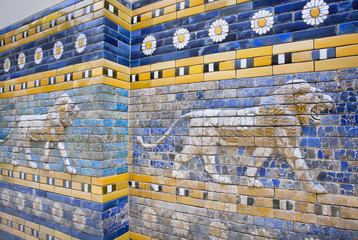 Lions following on the hunt, patterned wall of  the historical city of Babylon