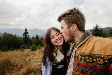 stylish beautiful traveling tender happy couple in the mountains