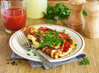 Breakfast omelet with tomatoes.