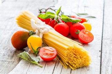 Raw pasta, tomato, basil