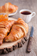 Three croissants on the dark wooden table, selective focus
