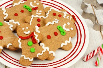 Group of Christmas gingerbread man cookies on a plate close up