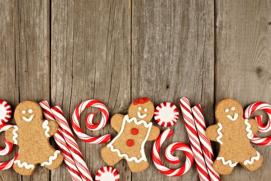 Christmas gingerbread cookies and peppermints on rustic wooden background - Powered by Adobe