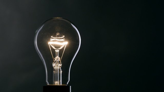 Light bulb over black background