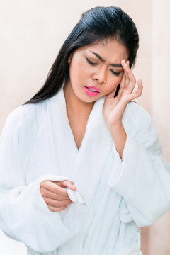 Asian woman taking painkillers for headache