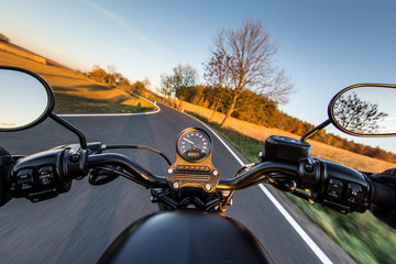 The view over the handlebars of a speeding motorcycle