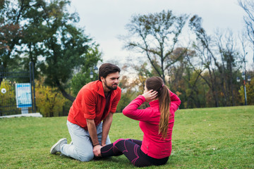 young sporty couple working out together outdoors