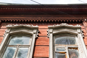Fototapeta na wymiar carved windows in an old wooden house