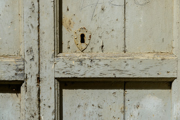 An old wooden door with a rusty lock.