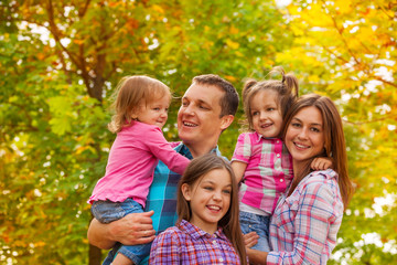 Happy family portrait with little girls outside